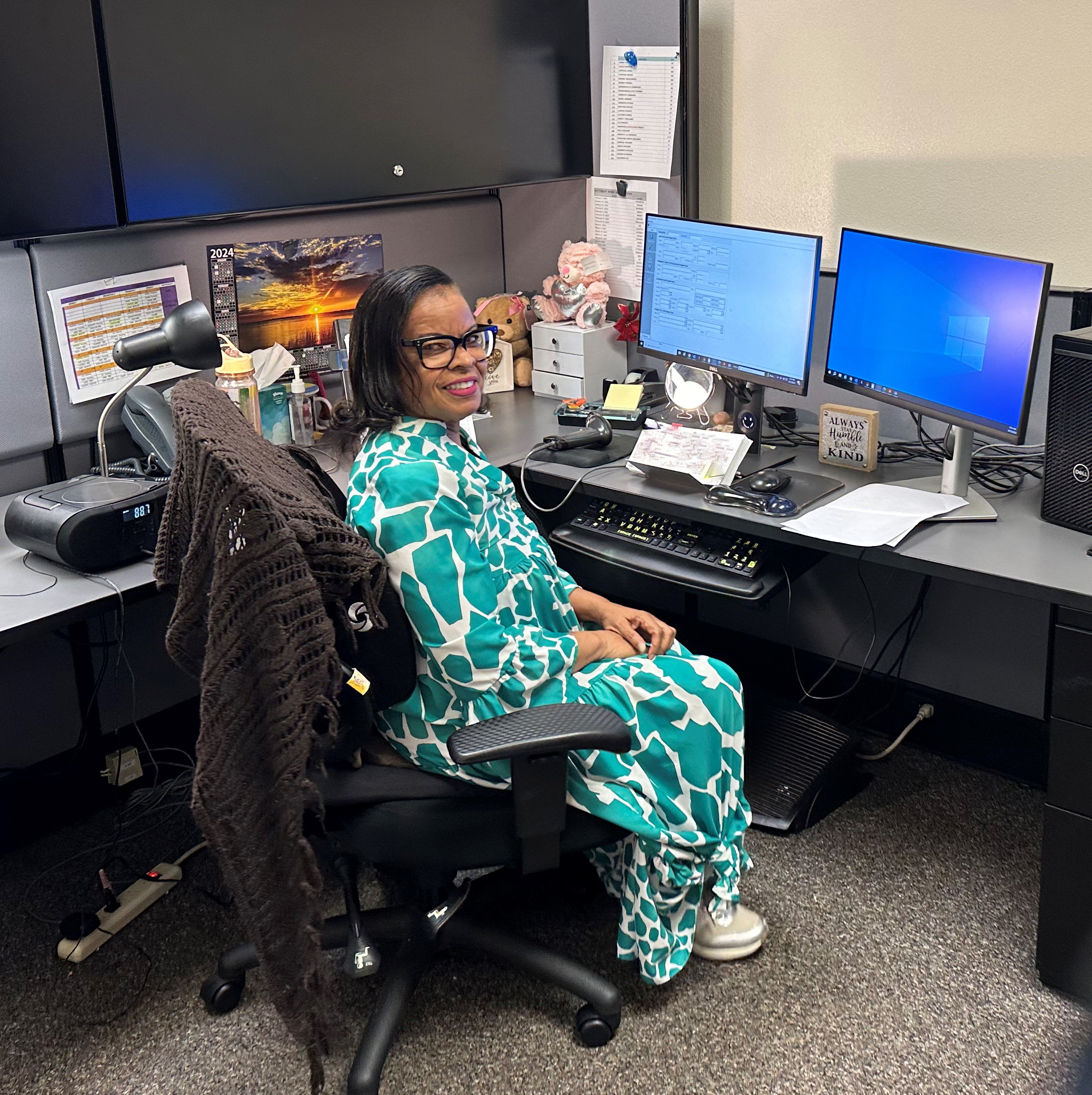 Smiling data entry personnel sitting at computer