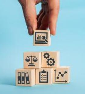 Illustration of a hand adding a building block to a stack