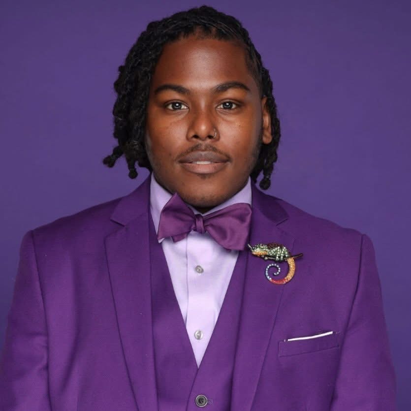 Andre wearing a purple suit