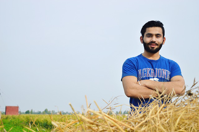 "Young farmworker standing in a field"