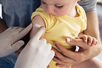 Child receiving immunization shot by a doctor