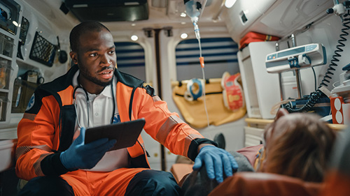 First responder employee helping a patient in ambulance