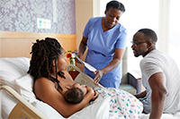 A new mother receiving breastfeeding support in a hospital.