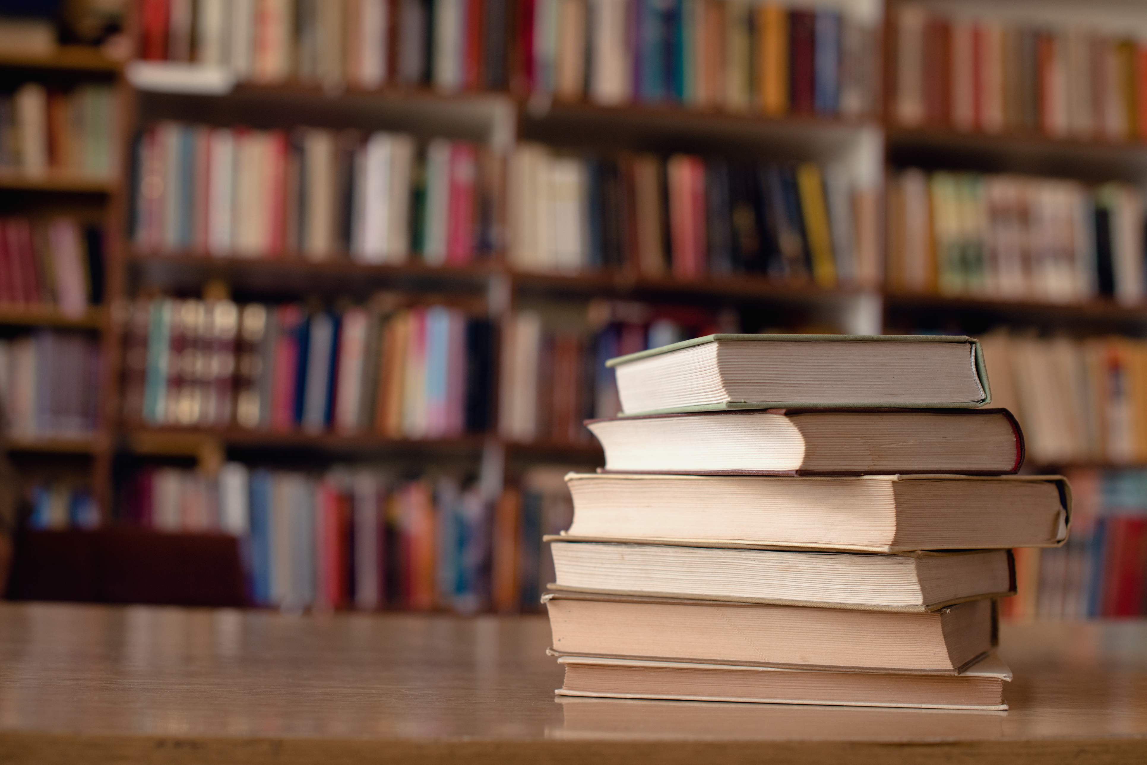 Books on a desk in a library.