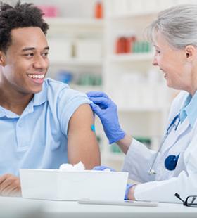 Man getting vaccinated by doctor