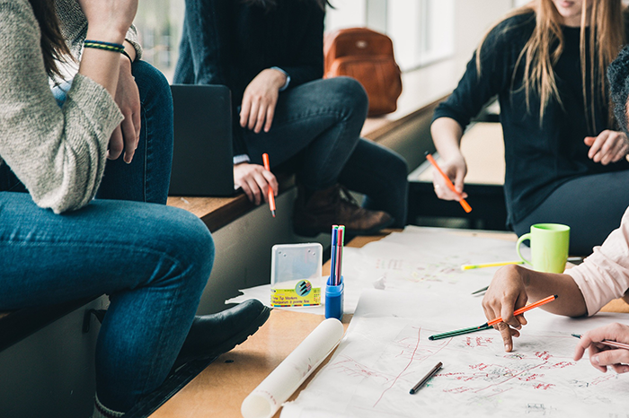 A group of students working together around a table.