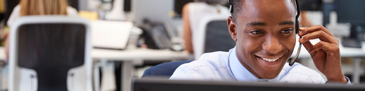 Customer service representative talking on a headset.