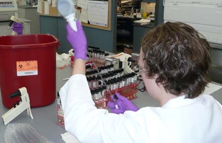 Researcher in lab performing testing.